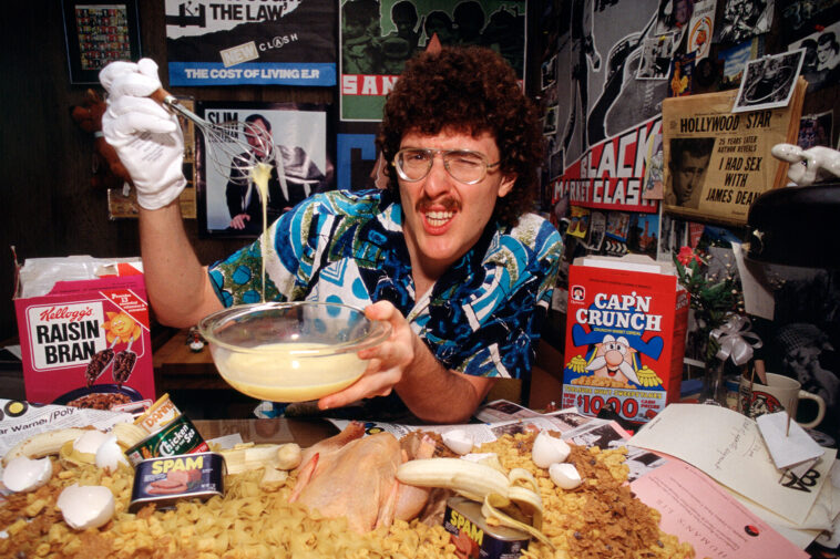 LOS ANGELES, CALIFORNIA -  MARCH 20 : Portrait of American musician, parodist, and comedian Weird Al Yankovic as he poses with various food items during a photo shoot, March 20, 1984 in Los Angeles, California.  (Photo by Getty Images/Bob Riha, Jr.)