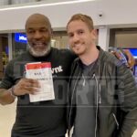 Mike Tyson posa para una foto con un fan minutos después de la golpiza del avión