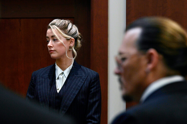 Actors Amber Heard and Johnny Depp, watch the jury arrive in the courtroom at the Fairfax County Circuit Courthouse in Fairfax, Va., Tuesday, May 17, 2022. Depp sued his ex-wife Amber Heard for libel in Fairfax County Circuit Court after she wrote an op-ed piece in The Washington Post in 2018 referring to herself as a "public figure representing domestic abuse." (Brendan Smialowski/Pool photo via AP)