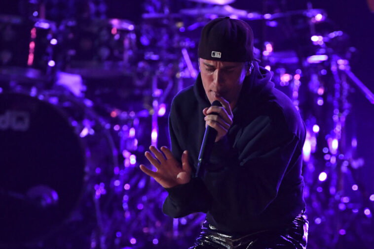 Canadian singer-songwriter Justin Bieber performs onstage during the 64th Annual Grammy Awards at the MGM Grand Garden Arena in Las Vegas on April 3, 2022. (Photo by VALERIE MACON / AFP) (Photo by VALERIE MACON/AFP via Getty Images)