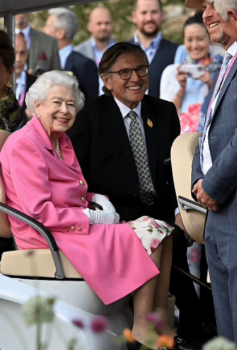 Queen Elizabeth II, in a hot pink coat dress, attended the Chelsea Flower Show on an eco-friendly golf cart