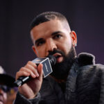 LONG BEACH, CALIFORNIA - OCTOBER 30: Drake speaks  onstage during Drake's Till Death Do Us Part rap battle on October 30, 2021 in Long Beach, California. (Photo by Amy Sussman/Getty Images)