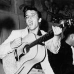 TAMPA, FL - JULY 31: Rock and roll singer Elvis Presley performs on stage with his brand new Martin D-28 acoustic guitar on July 31, 1955 at Fort Homer Hesterly Armory in Tampa, Florida. (Photo by Michael Ochs Archives/Getty Images)