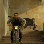 Owen Grady (Chris Pratt) and an Atrociraptor in Jurassic World Dominion, co-written and directed by Colin Trevorrow.