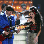 Mark Ronson, left, and Amy Winehouse perform at the 2008 Brit Awards in London, Feb. 20, 2008. (AP Photo/John Marshall, JME)