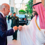 In this photo released by Saudi Press Agency (SPA), Saudi Crown Prince Mohammed bin Salman, right, greets President Joe Biden, with a fist bump after his arrival in Jeddah, Saudi Arabia, Friday, July 15, 2022. (Saudi Press Agency via AP)