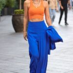 Puntal: Myleene Klass, de 44 años, hizo alarde de sus abdominales tonificados con un chaleco naranja y pantalones azul eléctrico mientras se dirigía al trabajo en Smooth FM en Londres el domingo.