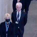 Presentando sus respetos: Phillip Schofield y Holly Willoughby cortaron figuras sombrías el viernes cuando fueron fotografiados uniéndose a los miles de británicos en duelo para ver el ataúd de la Reina en el Westminster Hall de Londres.