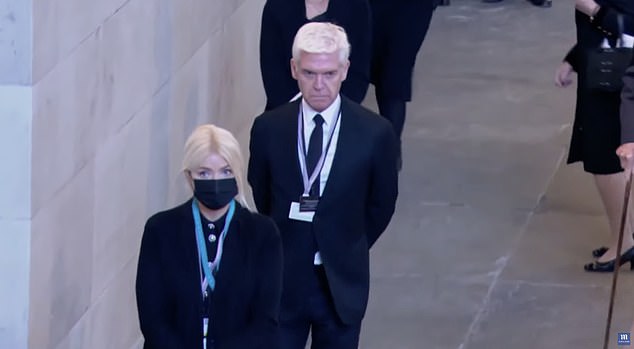 Presentando sus respetos: Phillip Schofield y Holly Willoughby cortaron figuras sombrías el viernes cuando fueron fotografiados uniéndose a los miles de británicos en duelo para ver el ataúd de la Reina en el Westminster Hall de Londres.