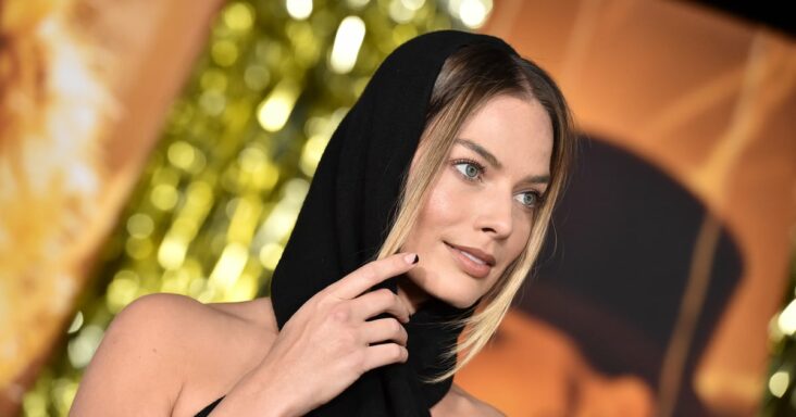 las uñas de espacio negativo de margot robbie combinan con el recorte de su vestido